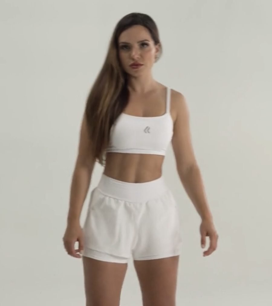 Top branco e short fitness com sobreposição
